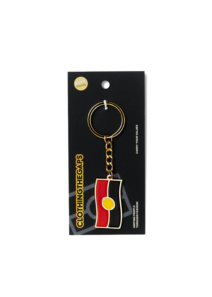 Clothing The Gaps. Keyring with gold chain and loop attached to Black, yellow and red aboriginal flag with skinny gold outline.