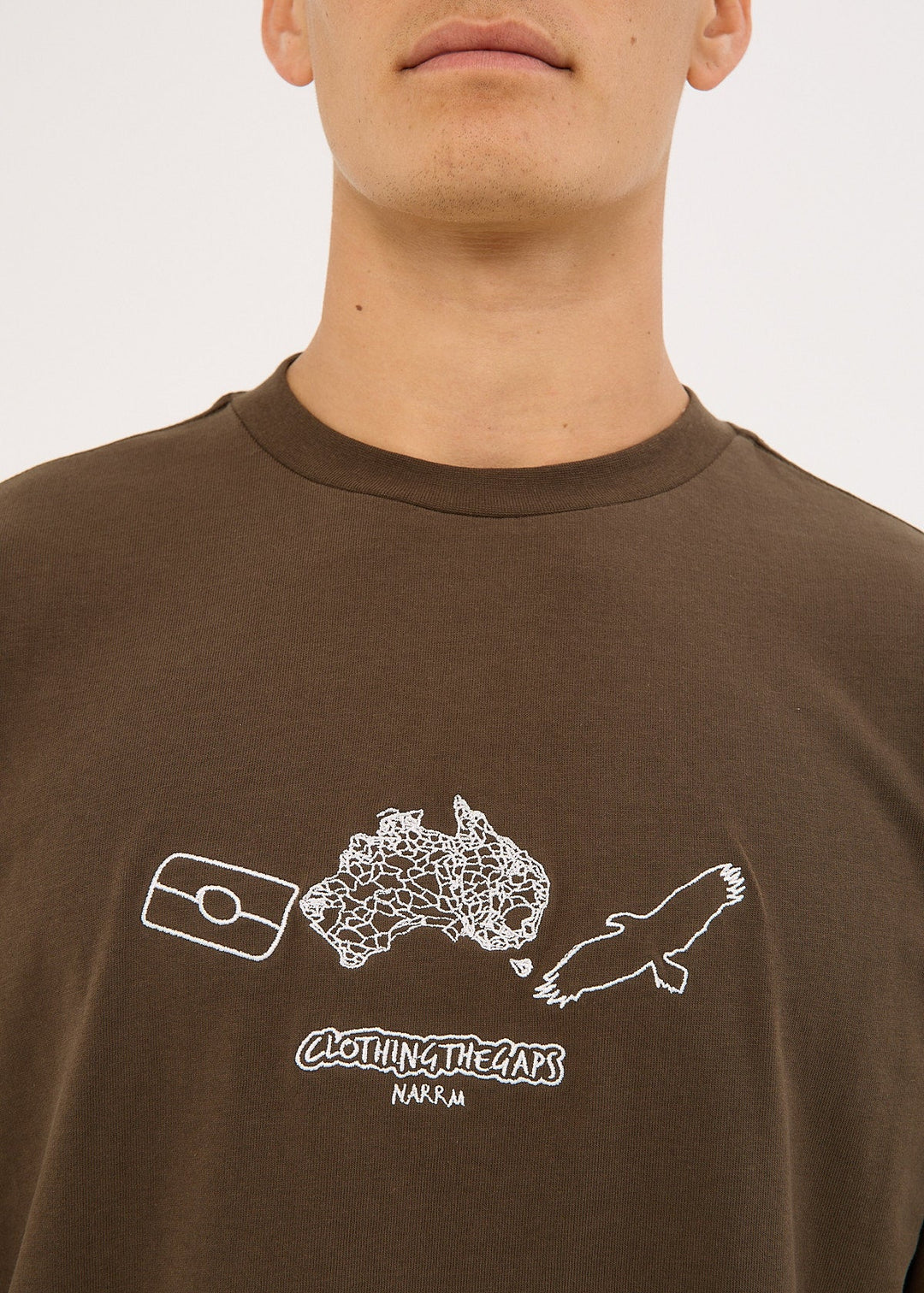 Clothing The Gaps Brown t-shirt with white embroidery graphic design on a plain background