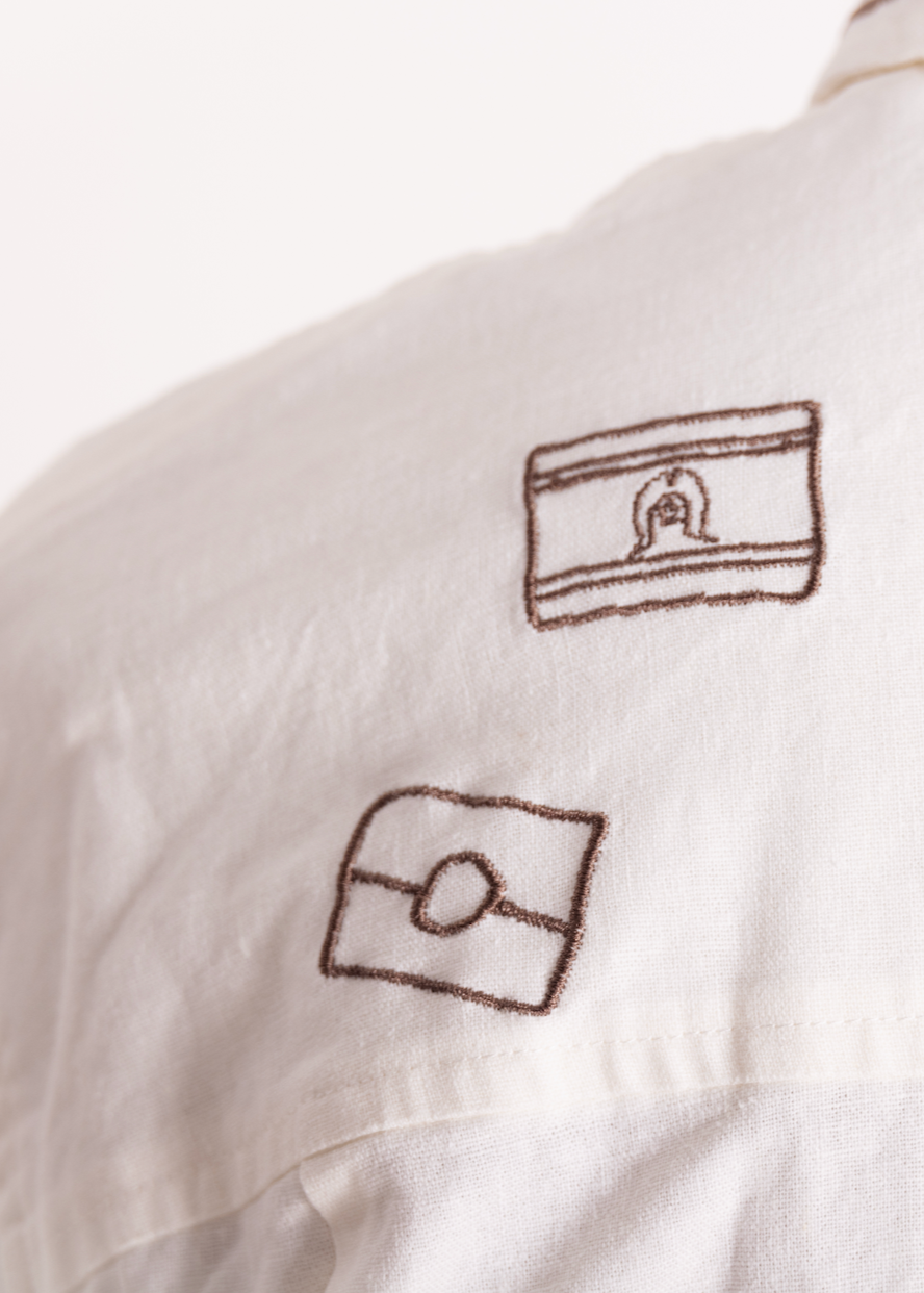 White shirt with embroidered  first nation flag designs on a white background