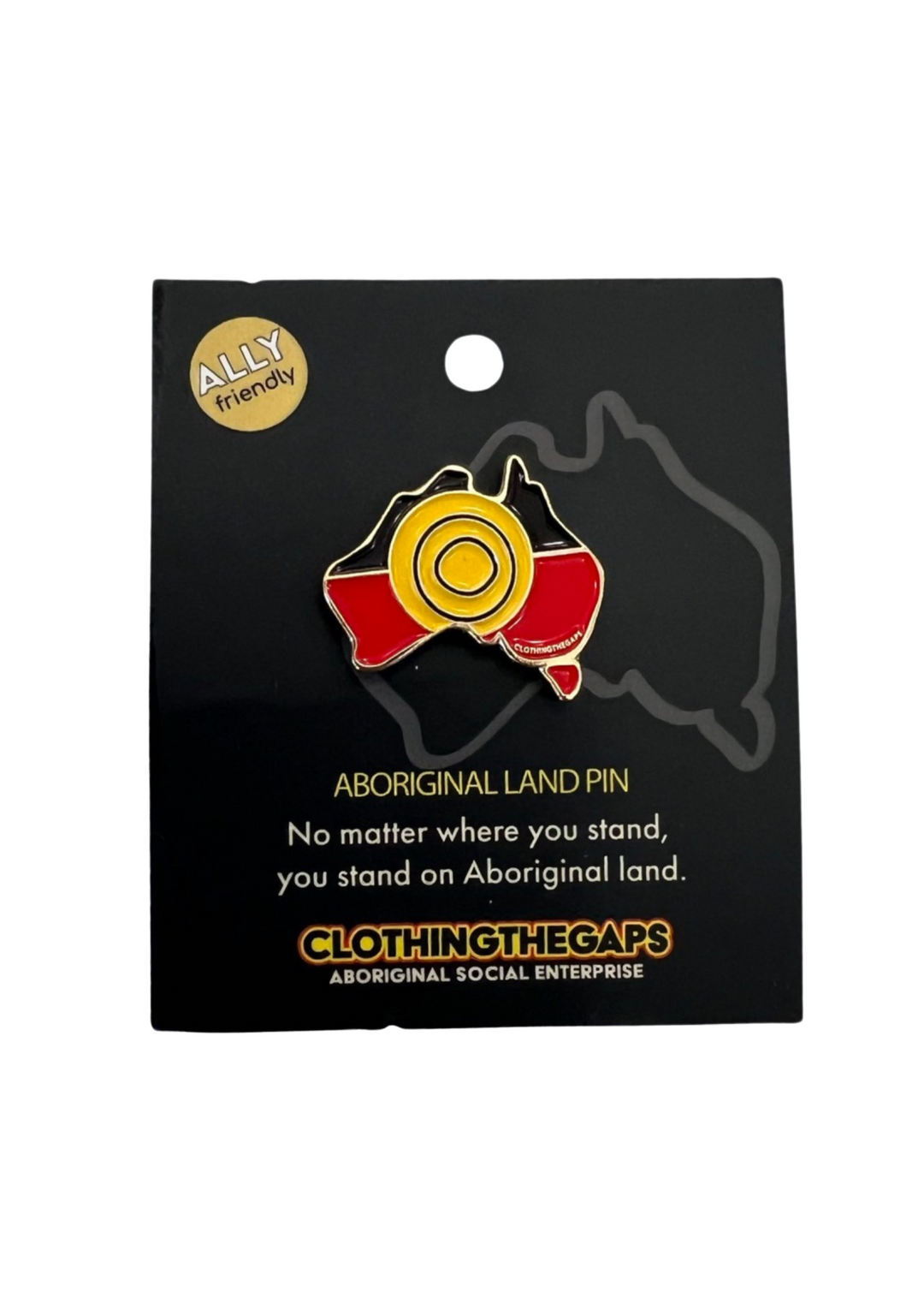 Clothing The Gaps. Pin. Black, yellow and red Aboriginal flag colours shaped inside map of Australia with gold outline and gold backing.