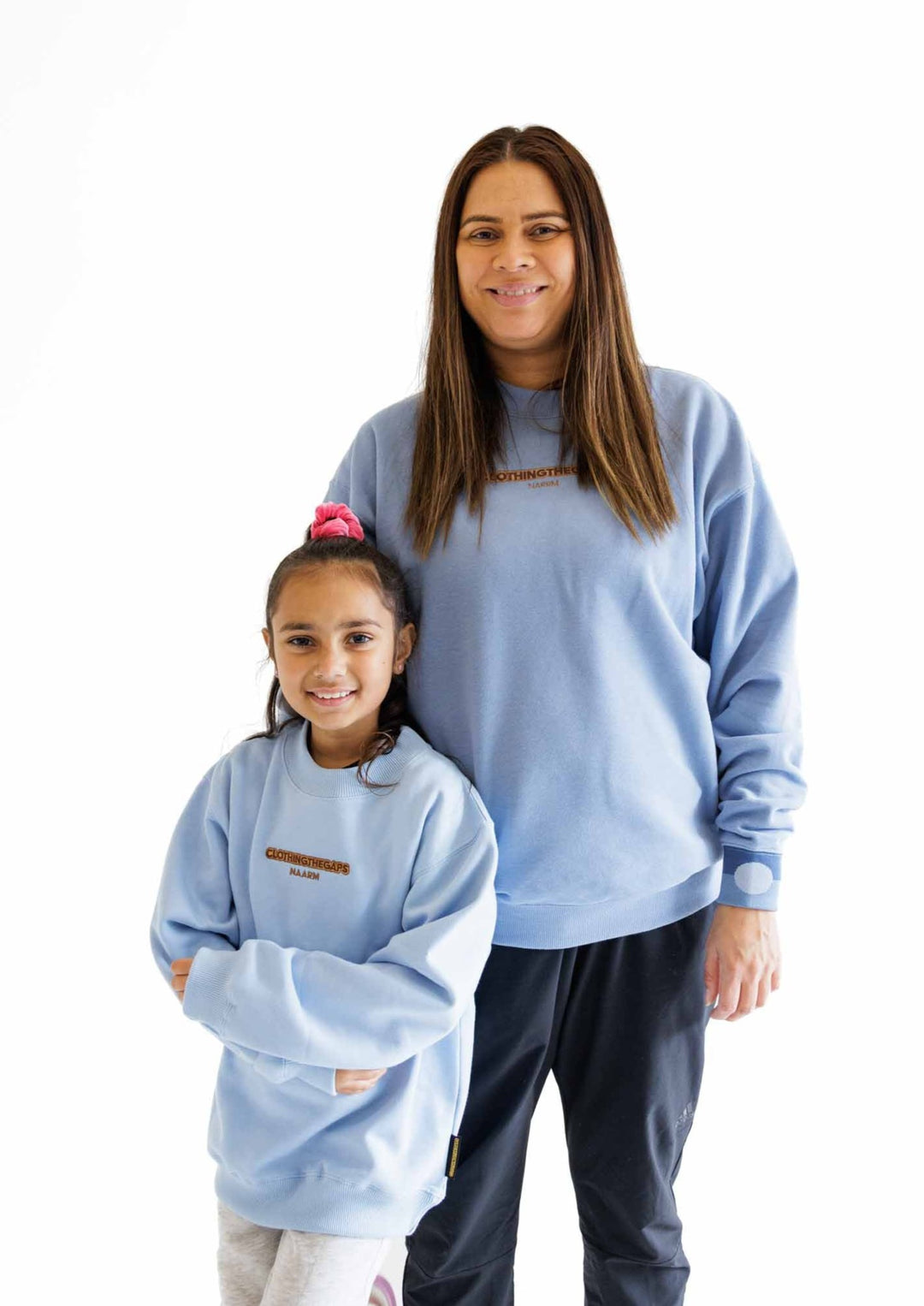 Clothing The Gaps. Kids Ice Blue Crew Jumper. Ice light blue crew neck jumper. With tonal brown 'Clothing the gaps' and the word 'Narrm' embroidered on the front of crewneck.' Woven ice light blue elastic wrist cuffs and waist band.