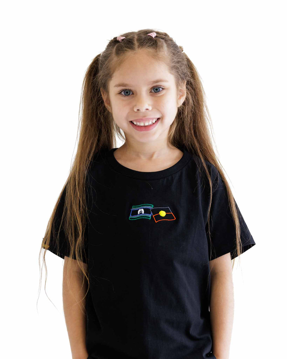 Clothing The Gaps. Kids First Nations Flags Tee. Black kids t-shirt with embroidered coloured Aboriginal and Torres Strait islander flag front and centre on tee.