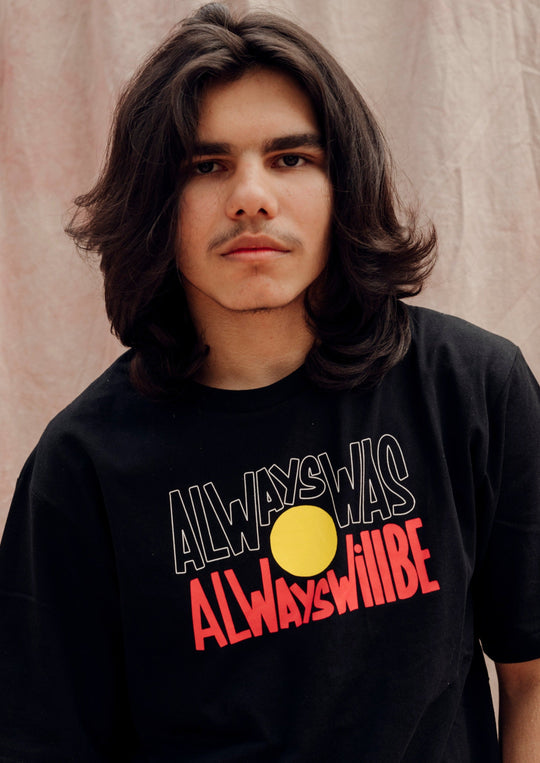 Clothing The Gaps. Black T-shirt with Black, yellow and red 'always was always will be' text screen printed in centre.