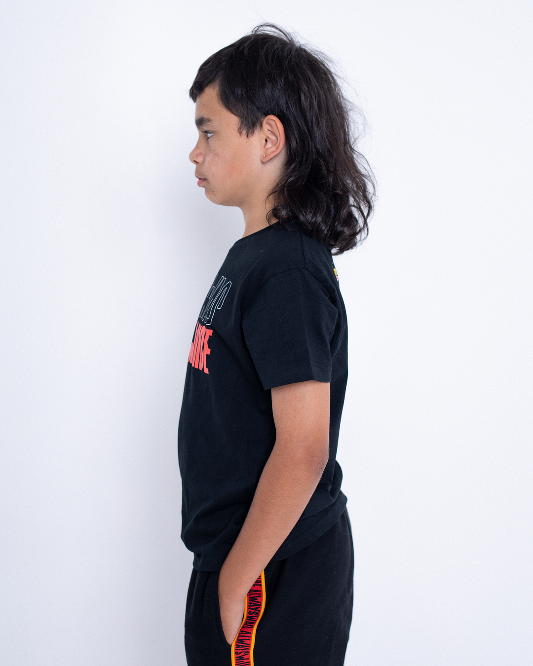 Clothing The Gaps. Black kids short sleeve T-shirt with Black, yellow and red 'always was always will be' text screen printed in centre.
