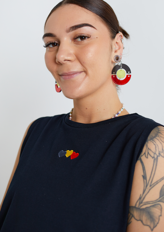 Clothing The Gaps. Blak Luv Tank. All black tank with  Red, black and yellow hearts embroiled on front.