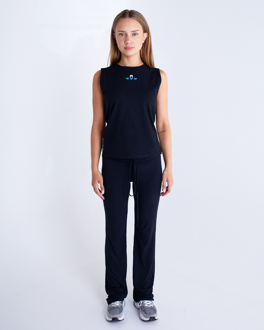 Clothing The Gaps. Our Islands Our Home Tank. All black tank with embroidered white Dhari on top of Green, Blue and Black hearts embroidered on front chest.
