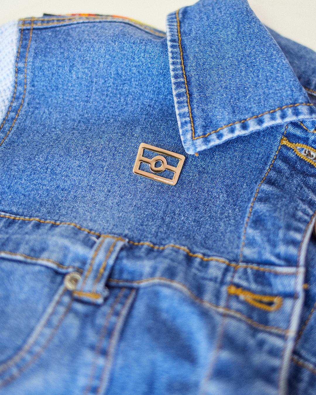 Clothing the Gaps. The Flag Pin. Gold Outline of aboriginal flag. with gold backing.