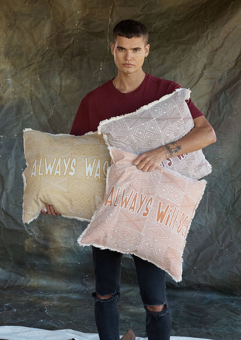 Clothing the Gaps. Cushion covers available in red, orange and yellow. With aboriginal possum skin cloak designed back ground and words 'always was' on one side and 'always will be' on the other. 