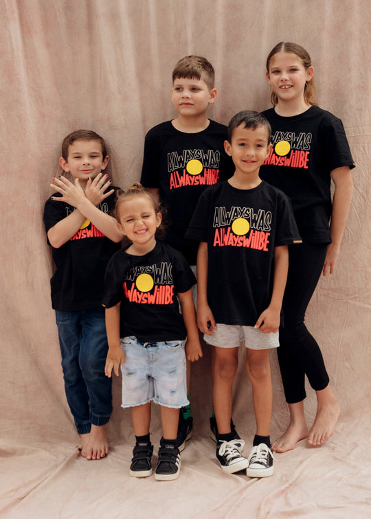 Clothing The Gaps. Black kids short sleeve T-shirt with Black, yellow and red 'always was always will be' text screen printed in centre.