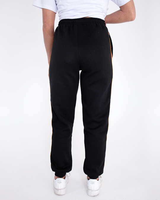 Clothing the Gaps. Black cotton Pants. With black drawstrings. Elastic cuts and waistband. Embroiled Clothing The Gaps logo. Black 'always was always will be' text on a red background with a yellow trim. In a cotton tape strip going down both sides of pants.