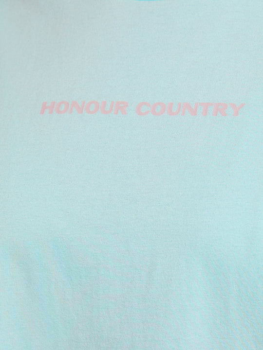 Clothing The Gaps. Mint Honour Country Tee. Light mint pastel green t-shirt with screen printed light grey bold capital text 'Honour and respect Aboriginal and Torres Strait Islander people as the rightful custodians of country.' The word 'Honour country' on the front in the same text and contrasting colour.