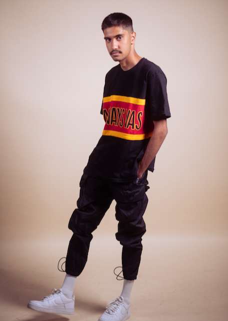 Clothing The Gaps. Power Rugby Tee. Red, black and yellow colorway. Black base tee with thick yellow top and bottom lines and red fill in mid section of jumper with big bold black text with a yellow outline in red section. Reading 'Always was' on front and on back in same text 'Always will be.'