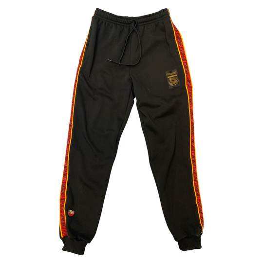 Clothing the Gaps. Black cotton Pants. With black drawstrings. Elastic cuts and waistband. Embroiled Clothing The Gaps logo. Black 'always was always will be' text on a red background with a yellow trim. In a cotton tape strip going down both sides of  pants.