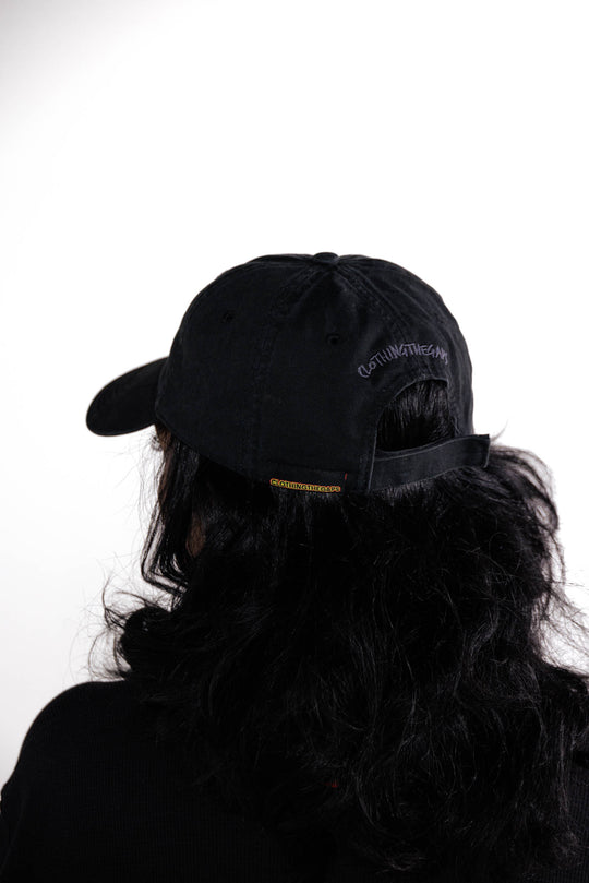 Clothing The Gaps. Blak Luv Cap. All black with  Red, black and yellow hearts embroidered on front. Clothing The Gaps embroidered on back in black stitching. Adjustable clip strap on back with silver clip featuring Clothing The Gaps logo.