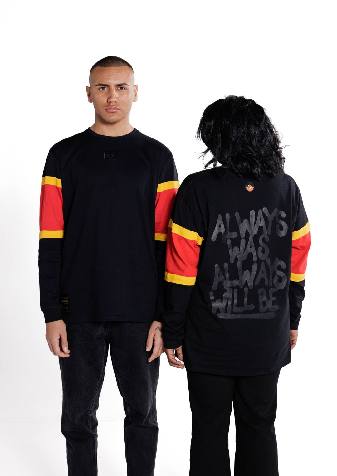 Clothing The Gaps. Black Power Longsleeve. Red, black and yellow sleeves. Aboriginal flag outline embroidered in black on the front. On the back of the hoodie a screen printed powerful Aboriginal chant 'Always Was, Always Will Be' looks like it has been sprayed on with a black spray can! The Clothing the Gaps circle logo patch of red, black and yellow just below neckline centred on upper back.