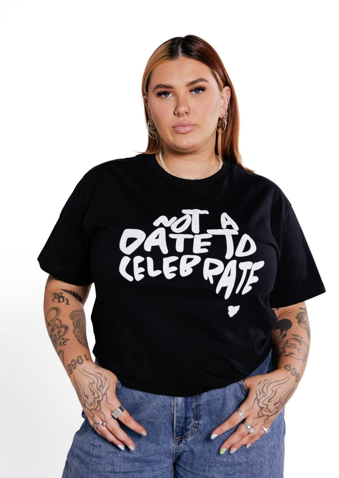 Clothing The Gaps. Not A Date To Celebrate Tee. Black tee with screen printed 'Not A Date To Celebrate' white text in the shape of Australia big on the front chest of t-shirt.