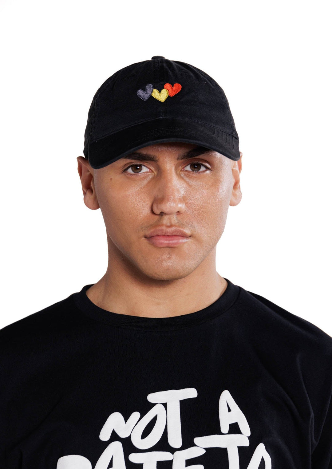 Clothing The Gaps. Blak Luv Cap. All black with  Red, black and yellow hearts embroidered on front. Clothing The Gaps embroidered on back in black stitching. Adjustable clip strap on back with silver clip featuring Clothing The Gaps logo.