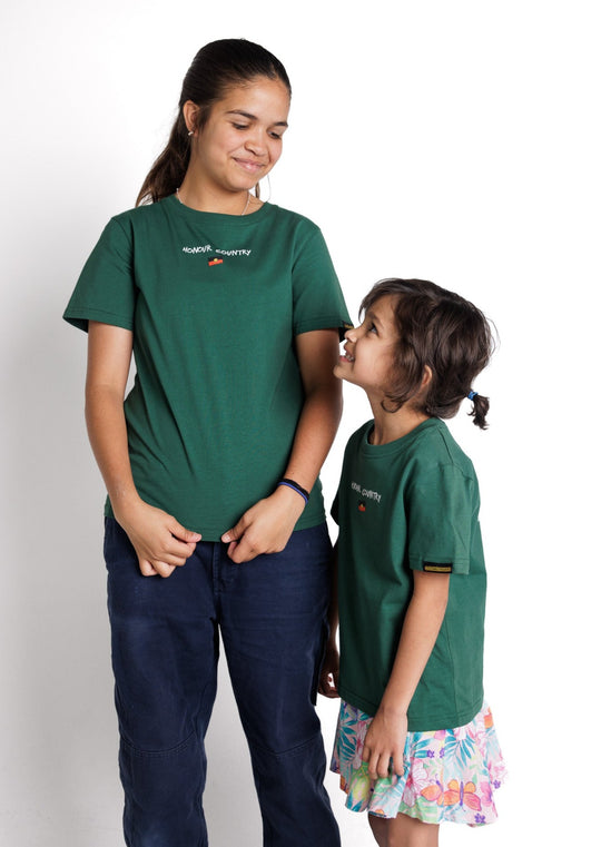 Clothing The Gaps. Kids Handwritten Honour Country Tee. Forrest green T-shirt with 'Honour Country' across chest in handwritten white text and coloured Aboriginal flag small underneath. On Back of tee white hand-writen style text 'Honour and respect Aboriginal and Torres Strait Islander people as the rightful custodians of country.' Circling 'respect' underlining 'custodians' and highlighting 'rightful' in a black colour. Outlined 'bunjil' eagle in bottom right corner.'        