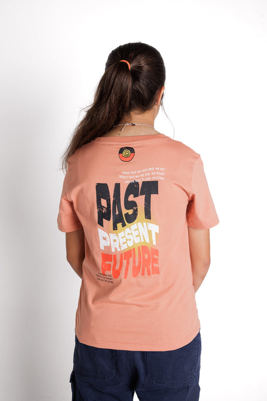 Clothing The Gaps. Kids Past Present Future Tee. Light peachy coloured tee with a small 'Past, Present, Future' pocket square on the front and large 'Past, Present , Future screen print back Black white and red with a yellow sun behind.