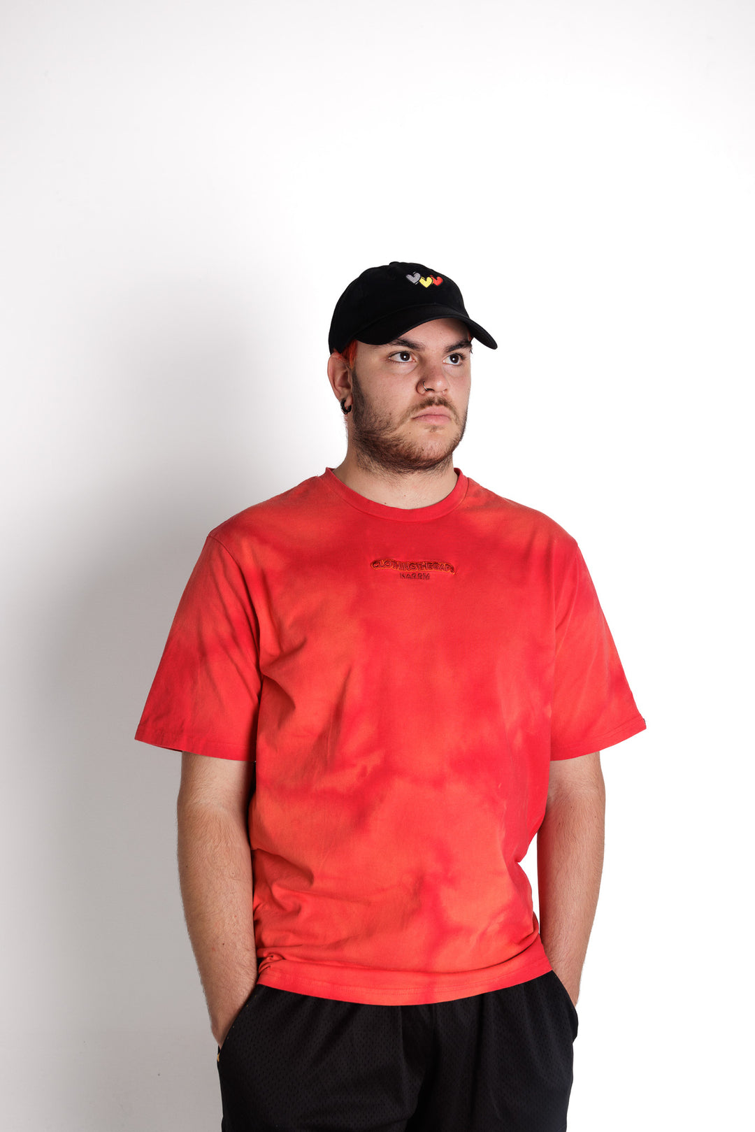 Clothing The Gaps. First Sunrise Tee. Red tee with an acid wash tie died look with varying darker red, lighter red and blood orange colours. Featuring embroidered  'Clothing The Gaps' in a darker contrasting red and 'Narrm,' underneath in the same darker red. 