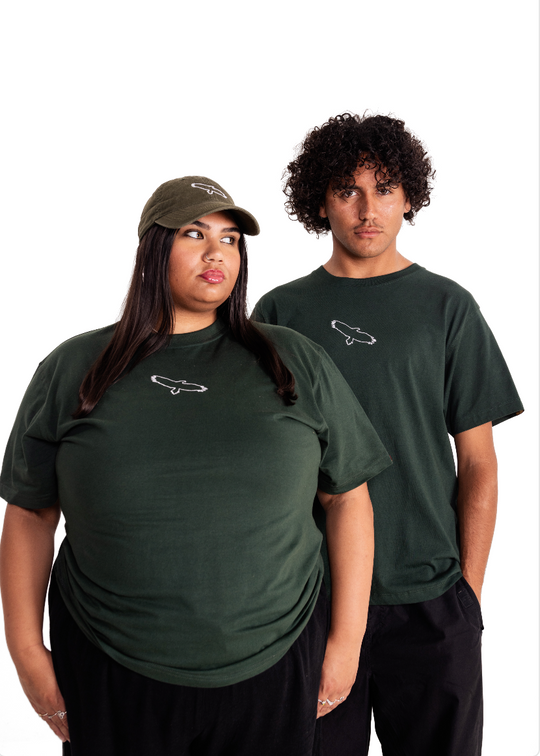 Two models wearing a forest green Aboriginal tee Bunjil eagle clothing the gap-shirt with a white embroidered design of a wedge-tailed eagle and the text 'Past, Present, Future' on it.