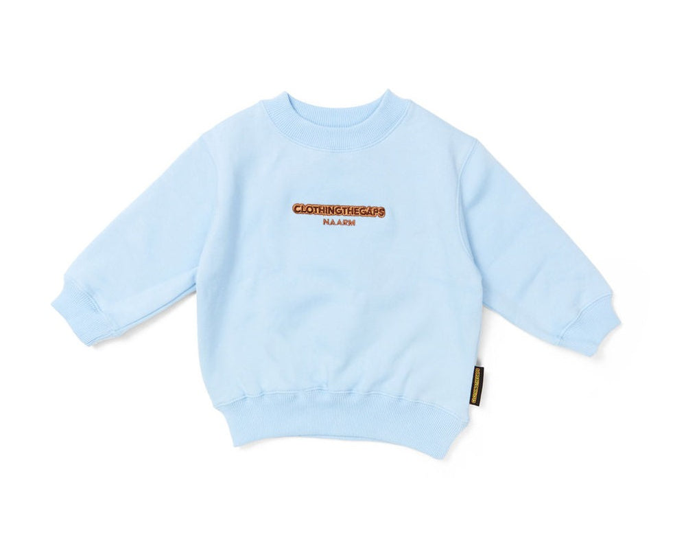 Clothing The Gaps. Kids Ice Blue Crew Jumper. Ice light blue crew neck jumper. With tonal brown 'Clothing the gaps' and the word 'Narrm' embroidered on the front of crewneck.' Woven ice light blue elastic wrist cuffs and waist band.