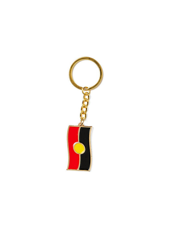 Clothing The Gaps. Keyring with gold chain and loop attached to Black, yellow and red aboriginal flag with skinny gold outline.