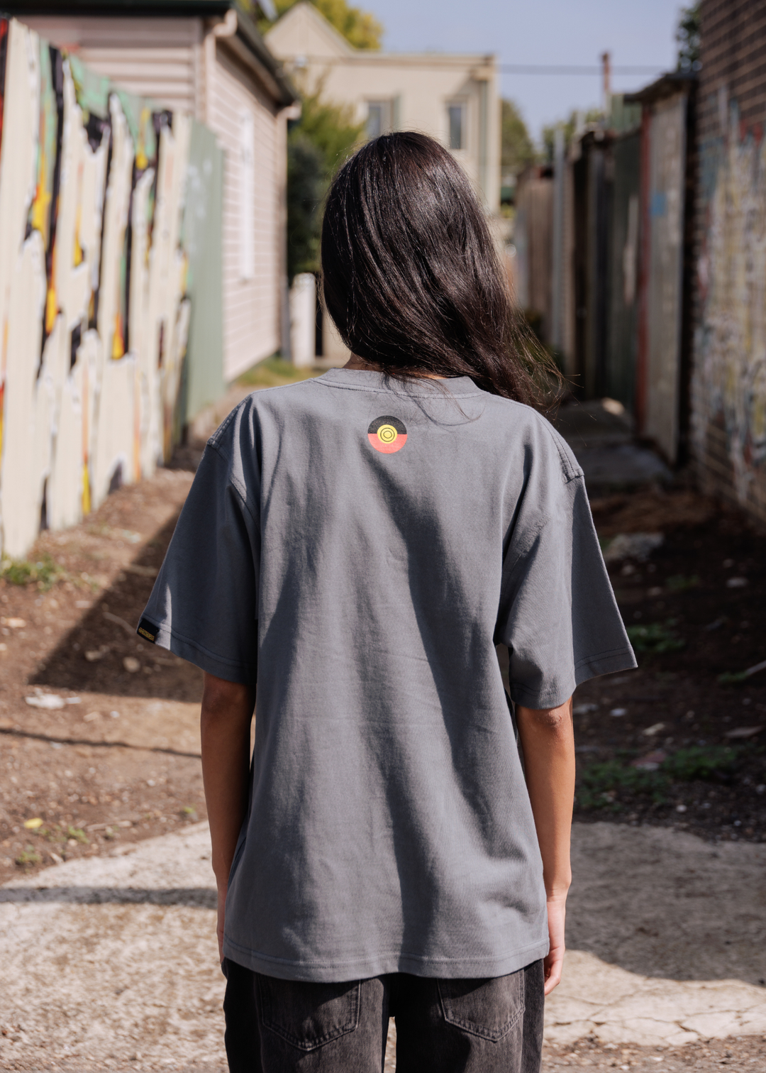 Clothing The Gaps No Room For Racism Tee — Grey Oversized Spray Paint Print Aboriginal Flag Outline Wurundjeri Country Screen Print Social Enterprise