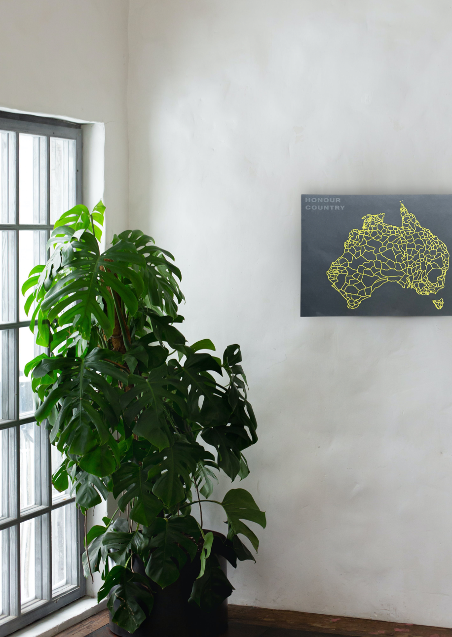Decolonised Map poster, yellow map of Australia showing 260 First Nations groups on black. Clothing The Gaps.