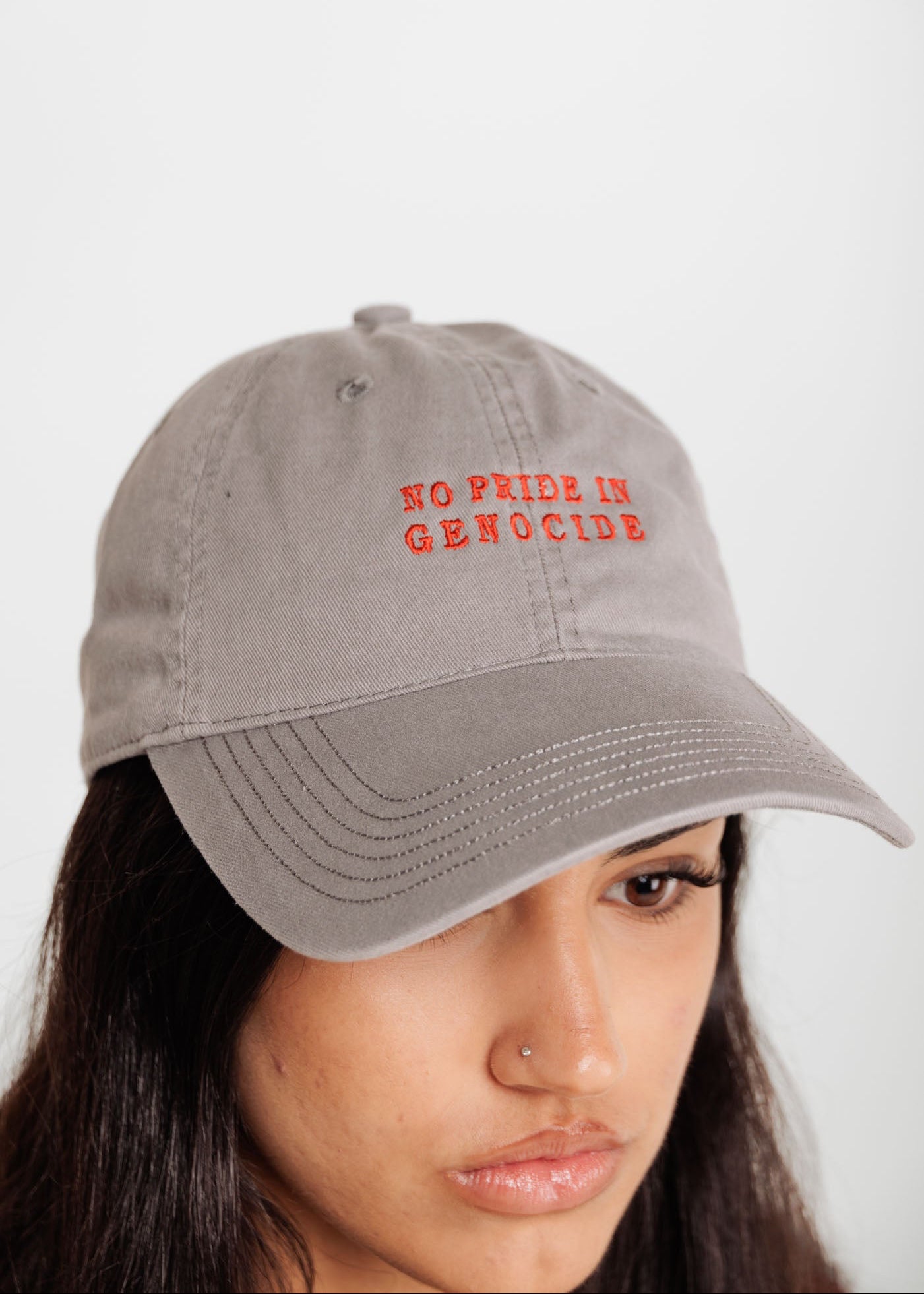 front of No Pride in Genocide cap clothing the gaps 