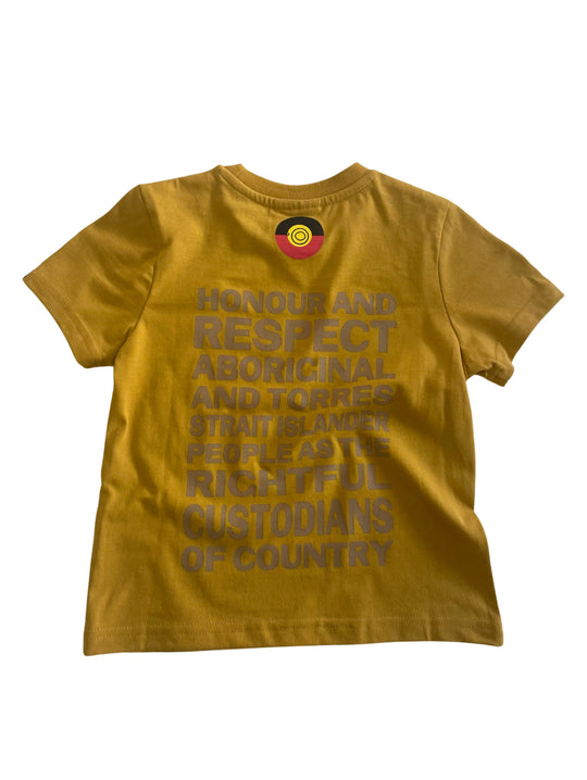 Clothing The Gaps. Kids Mustard Honour Country Tee. Mustard yellow t-shirt with screen printed bold capital text 'Honour and respect Aboriginal and Torres Strait Islander people as the rightful custodians of country.' The word 'Honour country' on the front in the same text and contrasting colour.