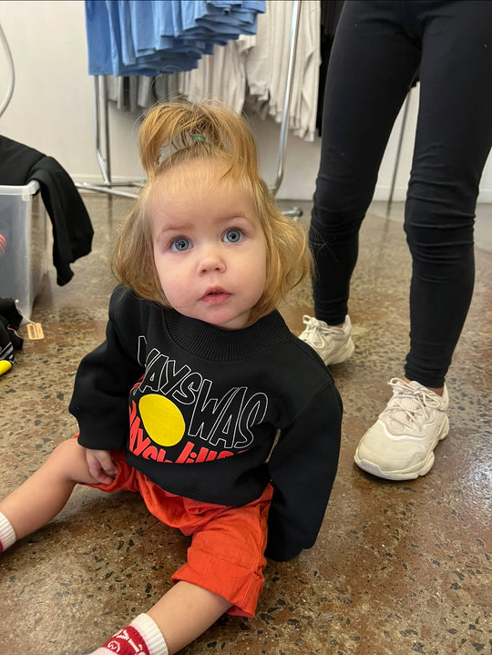 Clothing The Gaps. Black kids crew neck jumper with Black, yellow and red 'always was always will be' text screen printed in centre.