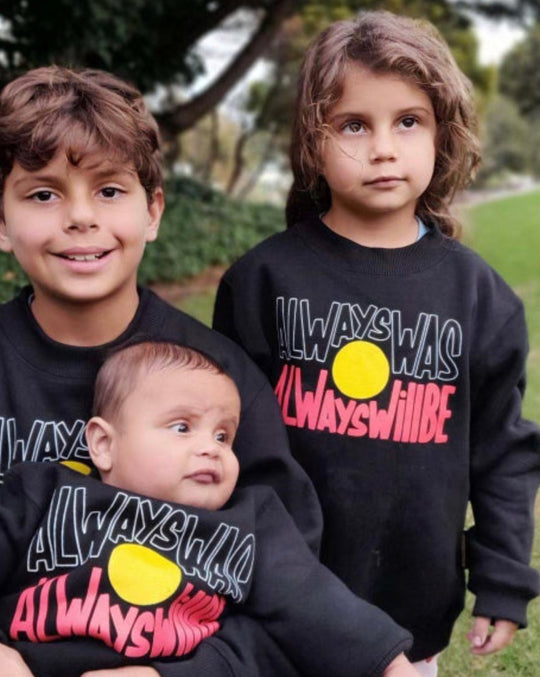 Clothing The Gaps. Black kids crew neck jumper with Black, yellow and red 'always was always will be' text screen printed in centre.