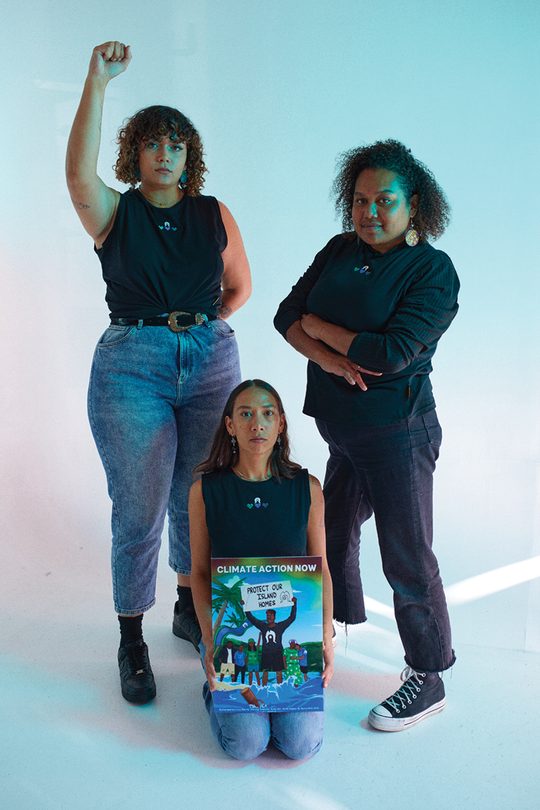 Clothing The Gaps. Our Islands Our Home Tank. All black tank with embroidered white Dhari on top of Green, Blue and Black hearts embroidered on front chest. 