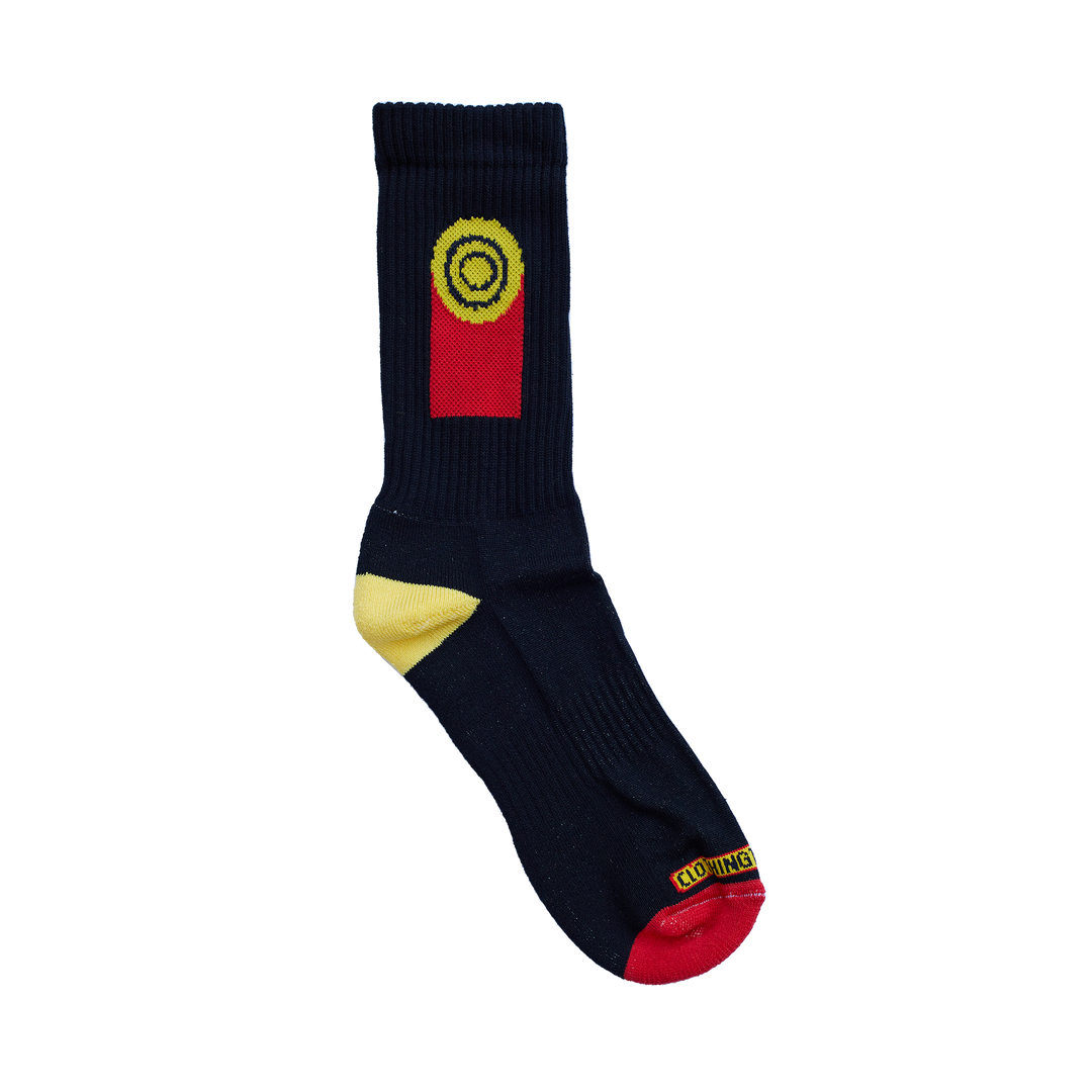 Clothing The Gaps. Flag Rights Socks. Long black socks with rectangle strips going down on both sides of socks representing the Clothing The Gaps logo and Aboriginal flag .With black at the top yellow circle in the middle with 2 black circular rings inside and red underneath the yellow. On both sides of each sock. Yellow on heel of socks. Red on toes of socks. Clothing The Gaps written above red section just going over toes.