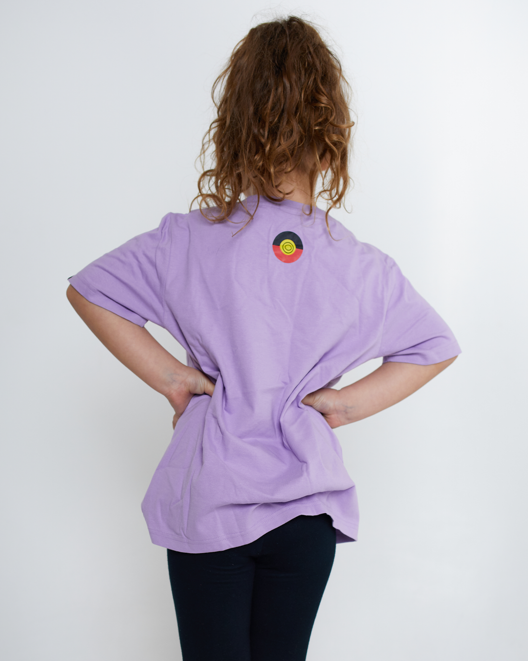Clothing The Gaps. KIDS Ltd Ed. Lilac 'Always Was, Always Will Be' Tee. Light lilac purple died t-shirt. With a Black, yellow and red 'always was always will be' text screen printed in left corner pocket sized.