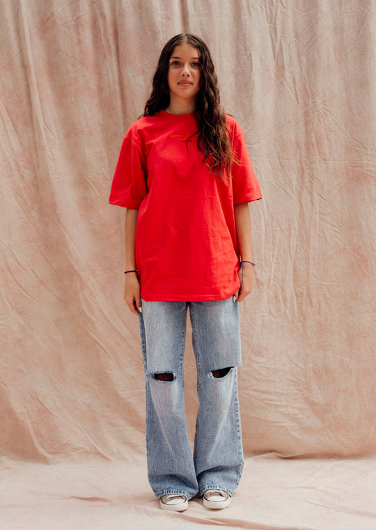 Clothing The Gaps. Land Tee. Red T-shirt. With embroidered 'Clothing The Gaps' on front chest with minimalist font in a contrasting light red colour and 'Narrm' in a dark red embroidered underneath, acknowledging the land on which Clothing The Gaps operates it's social enterprise.