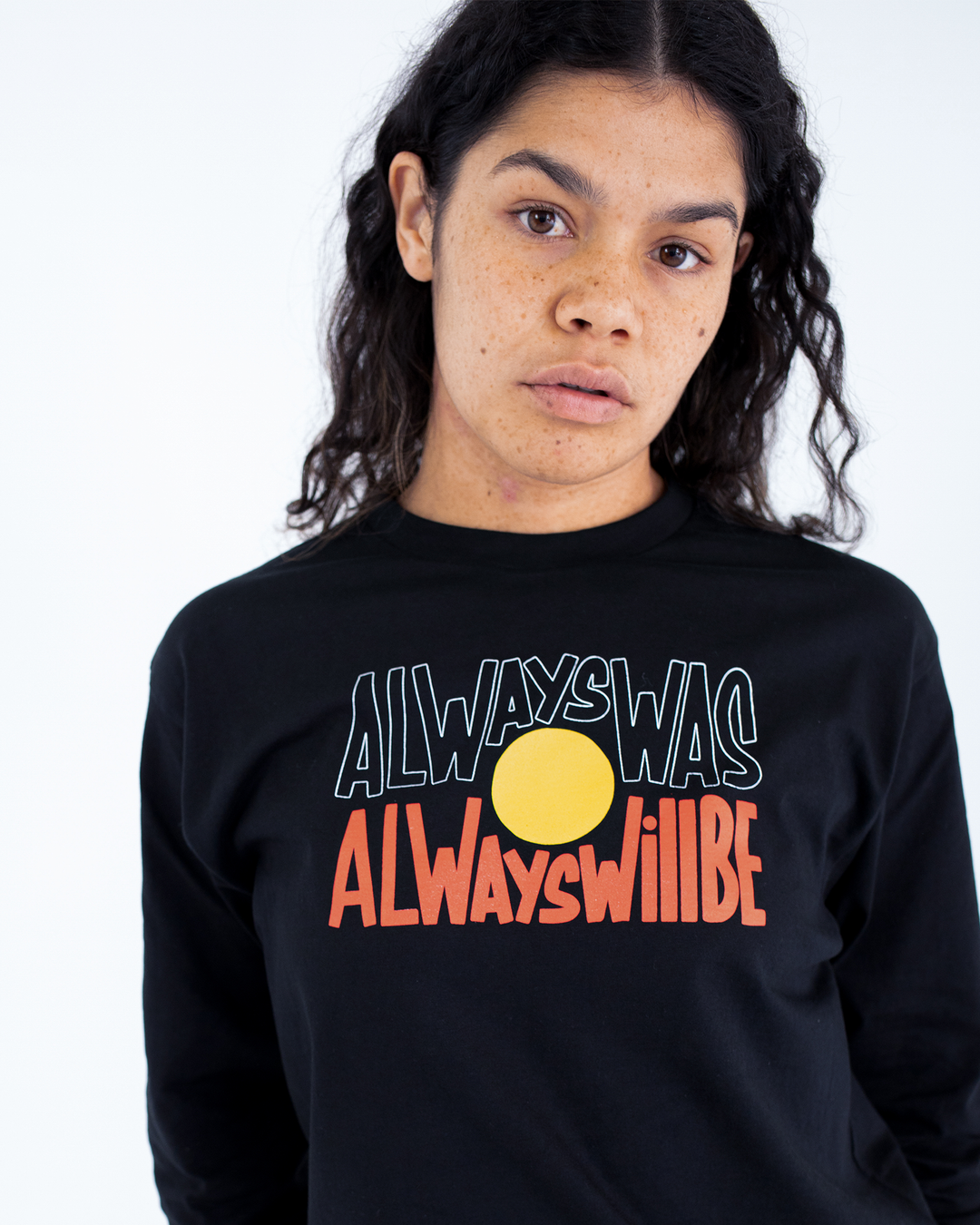 Clothing The Gaps. Black long sleeve T-shirt with Black, yellow and red 'always was always will be' text screen printed in centre.