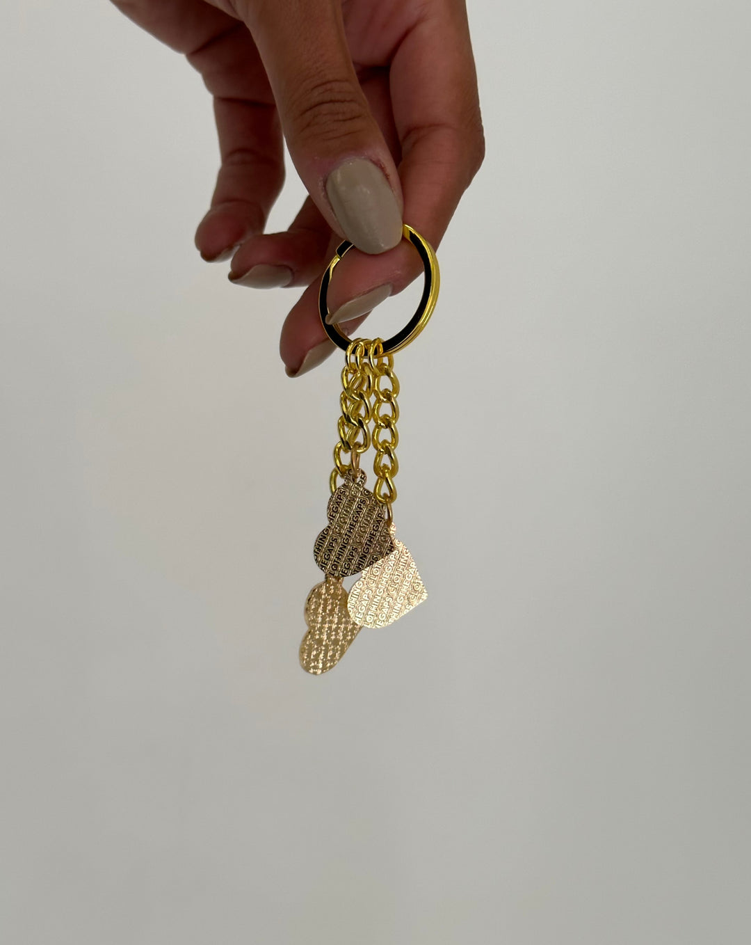 Clothing The Gaps. Blak Luv Keyring.  With gold chain and loop attached to 3 seperate hearts in the colours of the Aboriginal flag Black, yellow and red.