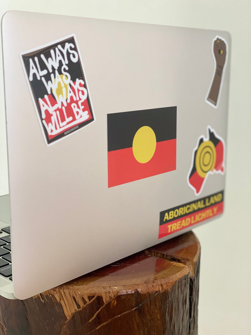 Clothing The Gaps. Black, Yellow and red Aboriginal flag sticker on laptop
