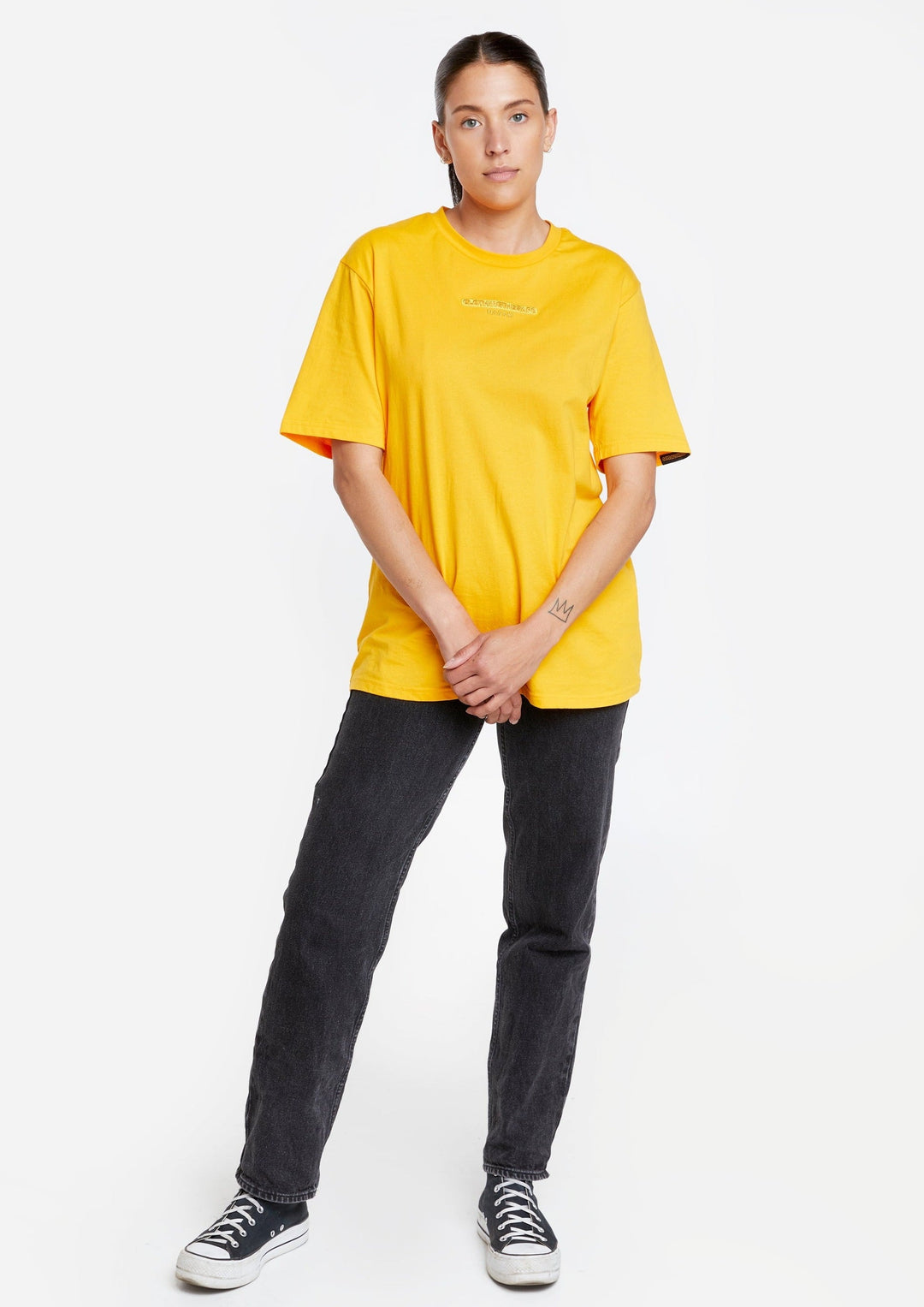 Clothing The Gaps. Sun Tee. Yellow T-shirt. With embroidered 'Clothing The Gaps' on front chest with minimalist font in a contrasting light yellow colour and 'Narrm' in a darker yellow embroidered underneath, acknowledging the land on which Clothing The Gaps operates it's social enterprise.