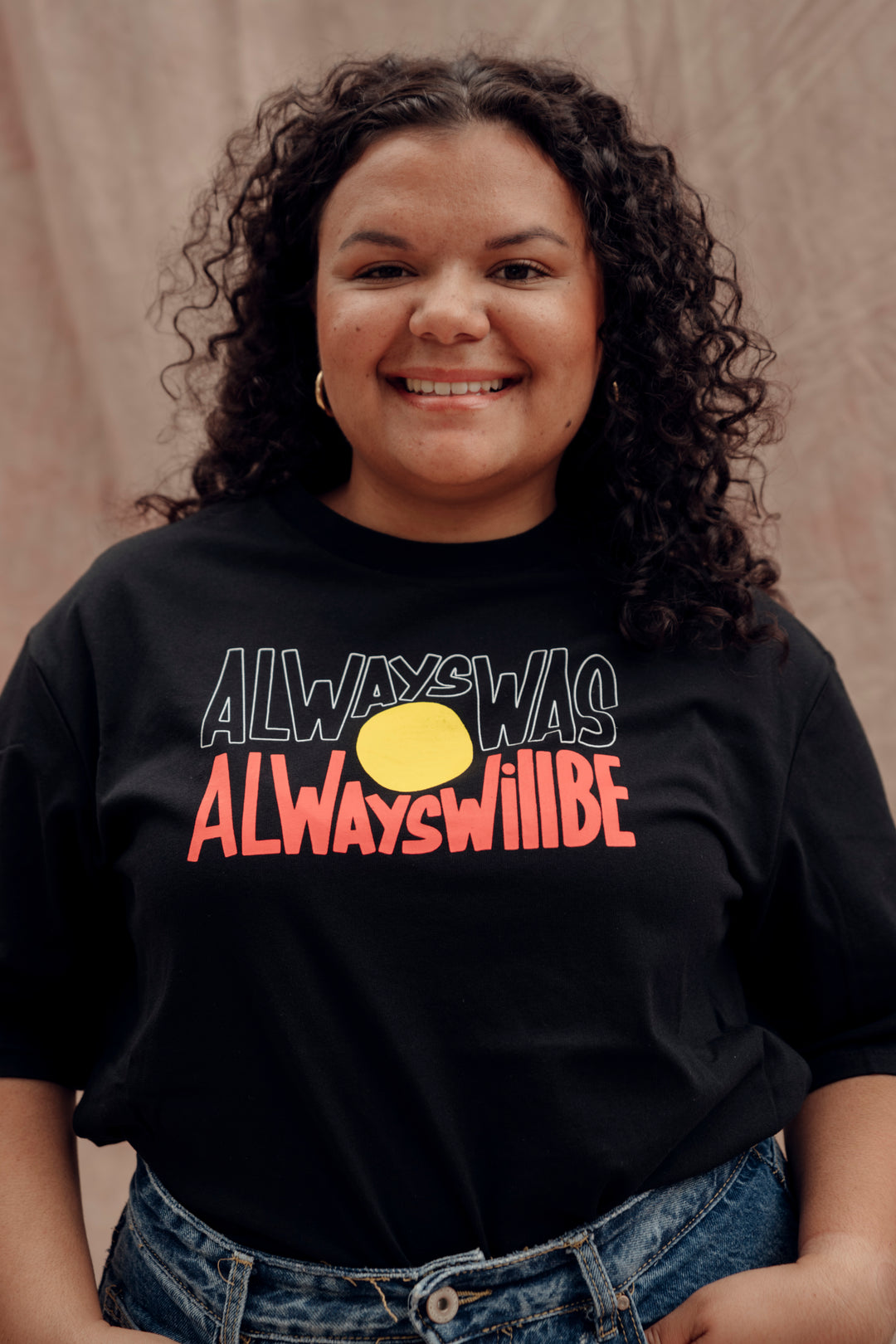 Clothing The Gaps. Black T-shirt with Black, yellow and red 'always was always will be' text screen printed in centre.